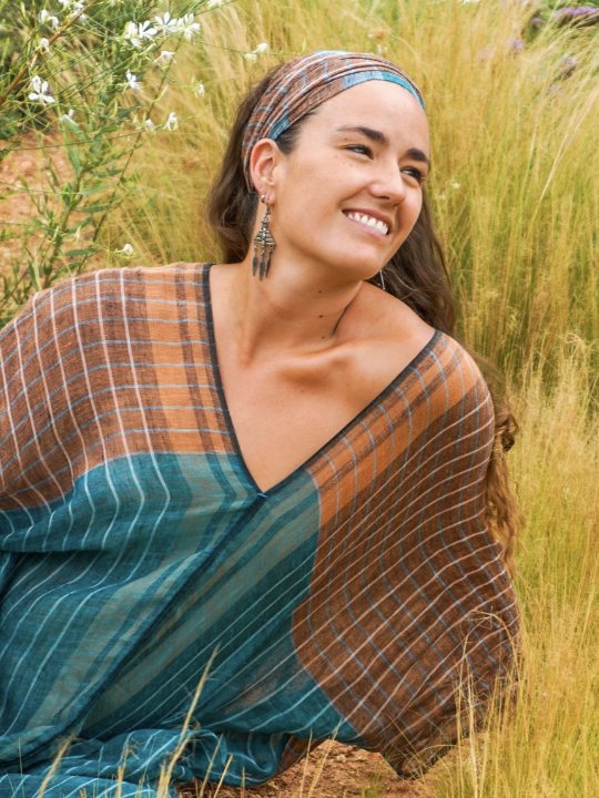 María sonriendo entre pastos altos